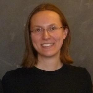 Photo of Margaret Scheuermann wearing glasses and black round-neck sweater.