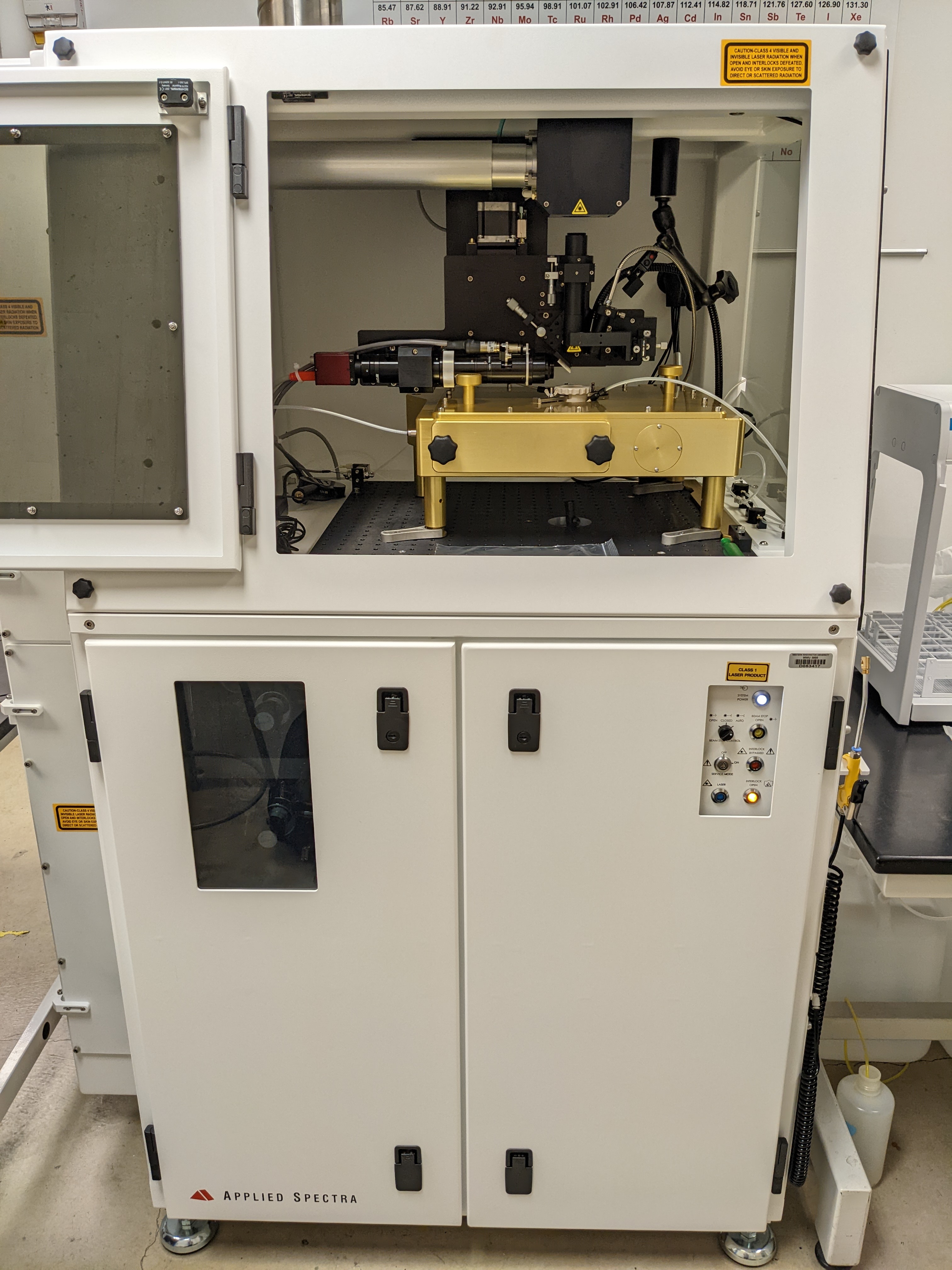 Applied Spectra Inc, RESOlution-SE 193nm Laser Ablation Accessory. Large white steel cabinet with optics inside.