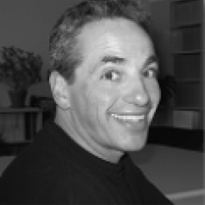 Black and white portrait of Mark wearing a black turtlneck