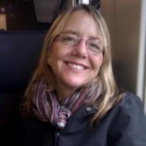 Ruth Sofield wearing glasses, scarf and dark colored jacket